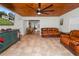 Spacious living room with leather sofas and wood-paneled ceiling at 210 Wilder Rd, Lakeland, FL 33809