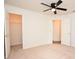 Bedroom with ceiling fan, walk-in closet and access to hallway at 2888 Hickory Ridge Dr, Lakeland, FL 33813