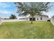 Spacious backyard, grassy area, and large tree at 332 Lake Mariana Way, Auburndale, FL 33823
