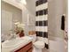 Clean bathroom with tub and striped shower curtain at 332 Lake Mariana Way, Auburndale, FL 33823