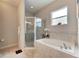 Clean bathroom featuring a shower and bathtub at 332 Lake Mariana Way, Auburndale, FL 33823