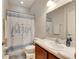 Clean bathroom with shower/tub combo and a cheerful shower curtain at 332 Lake Mariana Way, Auburndale, FL 33823