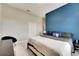 Bright bedroom with king-size bed and a blue accent wall at 332 Lake Mariana Way, Auburndale, FL 33823