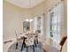 Bright dining area with a table and chairs, large windows, and stylish rug at 332 Lake Mariana Way, Auburndale, FL 33823