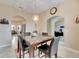 Bright dining room with marble-top table and kitchen view at 332 Lake Mariana Way, Auburndale, FL 33823