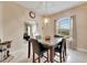 Dining room with a marble table, four chairs, and a view of the kitchen at 332 Lake Mariana Way, Auburndale, FL 33823
