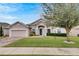Single-story house with a two-car garage and well-manicured lawn at 332 Lake Mariana Way, Auburndale, FL 33823