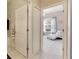 A view down a hallway with access to a bedroom and bathroom at 332 Lake Mariana Way, Auburndale, FL 33823