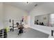 Well-equipped home gym featuring weightlifting equipment and mats at 332 Lake Mariana Way, Auburndale, FL 33823