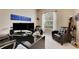 Home office with large desk, comfortable seating, and natural light at 332 Lake Mariana Way, Auburndale, FL 33823