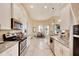 Modern kitchen with white cabinets, granite counters, and stainless steel appliances at 332 Lake Mariana Way, Auburndale, FL 33823