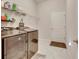 Laundry room with washer, dryer, and storage shelves at 332 Lake Mariana Way, Auburndale, FL 33823
