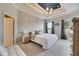 Main bedroom with a king-size bed and an ensuite bathroom at 332 Lake Mariana Way, Auburndale, FL 33823