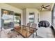 Screened porch with glass table and chairs, overlooks backyard at 332 Lake Mariana Way, Auburndale, FL 33823