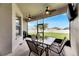 Relaxing screened porch with seating area and backyard view at 332 Lake Mariana Way, Auburndale, FL 33823