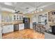 Updated kitchen with stainless steel appliances and terracotta tile floors at 4409 Hallam Hill Ln, Lakeland, FL 33813