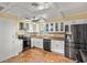 Updated kitchen with stainless steel appliances and terracotta tile floors at 4409 Hallam Hill Ln, Lakeland, FL 33813