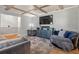 Living room with sectional sofa, wood-look flooring, and exposed beams at 4409 Hallam Hill Ln, Lakeland, FL 33813