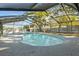 Enclosed kidney-shaped pool with screened enclosure at 4409 Hallam Hill Ln, Lakeland, FL 33813