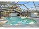 Inviting kidney-shaped pool with screened enclosure at 4409 Hallam Hill Ln, Lakeland, FL 33813