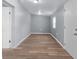 Light grey walls, wood-look flooring and bright windows in this empty bedroom at 515 S Charleston Ave, Fort Meade, FL 33841