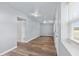 Simple bedroom with light grey walls, wood-look floors, and a window with blinds at 515 S Charleston Ave, Fort Meade, FL 33841