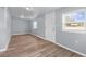 Empty bedroom with light grey walls, wood-look flooring, and a window with blinds at 515 S Charleston Ave, Fort Meade, FL 33841