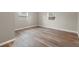 Bright bedroom with wood-look floors and two windows at 515 S Charleston Ave, Fort Meade, FL 33841