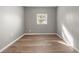 Bright bedroom with wood-look floors and a window with blinds at 515 S Charleston Ave, Fort Meade, FL 33841