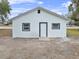 Newly renovated house exterior, white with grey trim at 515 S Charleston Ave, Fort Meade, FL 33841