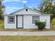 Newly renovated home features a white exterior, grey accents, and a well-maintained lawn at 515 S Charleston Ave, Fort Meade, FL 33841