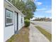 Newly renovated home with a white exterior, grey accents, and a sidewalk along a road at 515 S Charleston Ave, Fort Meade, FL 33841