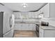 Modern kitchen with white cabinets, granite countertops, and stainless steel appliances at 515 S Charleston Ave, Fort Meade, FL 33841