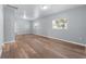 Spacious living area with grey walls, wood-look flooring, and multiple windows at 515 S Charleston Ave, Fort Meade, FL 33841