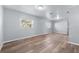 Spacious living area with light grey walls and wood-look flooring at 515 S Charleston Ave, Fort Meade, FL 33841