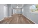 Large living room with grey walls, wood-look floors, and plenty of natural light at 515 S Charleston Ave, Fort Meade, FL 33841