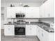 Modern kitchen with white cabinets and marble countertops at 5398 Duxford Cir, St Cloud, FL 34771