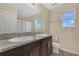 Bathroom with double sinks, granite countertop, and a shower/tub combo at 5460 Siltstone St, Lakeland, FL 33811