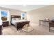 Spacious bedroom with wood bed frame, carpeted floor, and plenty of natural light at 5460 Siltstone St, Lakeland, FL 33811