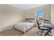 Bright bedroom with a double bed, desk, and window view at 5460 Siltstone St, Lakeland, FL 33811