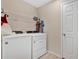 Bright laundry room, washer, dryer, and ample shelving at 5460 Siltstone St, Lakeland, FL 33811