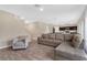 Spacious living room with L-shaped sofa and view of kitchen at 5460 Siltstone St, Lakeland, FL 33811