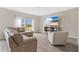 Living room with L-shaped sofa, armchair, and large TV at 5460 Siltstone St, Lakeland, FL 33811