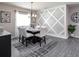 Elegant dining room with a modern light fixture and geometric wall detail at 549 Silver Course Radl, Ocala, FL 34472