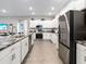 Open concept kitchen with island, stainless steel appliances and grey flooring at 549 Silver Course Radl, Ocala, FL 34472