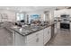Open concept kitchen with island, stainless steel appliances, and grey cabinets at 549 Silver Course Radl, Ocala, FL 34472