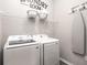 Bright laundry room features washer, dryer, and ample shelving at 549 Silver Course Radl, Ocala, FL 34472