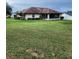 Large backyard with grassy area and a screened patio at 5805 Danterbury Ct, Lakeland, FL 33810