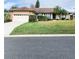 Single-story house with attached garage, landscaping, and a palm tree at 5805 Danterbury Ct, Lakeland, FL 33810