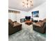 Spacious living room featuring brown leather sofas, a coffee table, and a large TV at 5805 Danterbury Ct, Lakeland, FL 33810